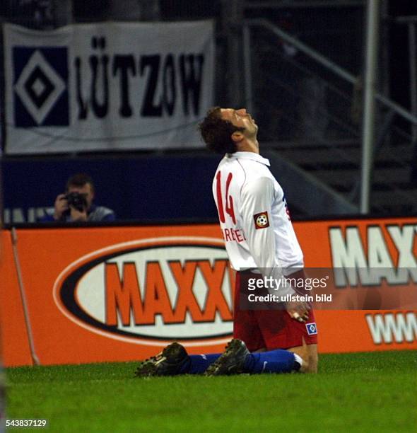 Sergej Barbarez *- Sportler, Fußball, Bosnien-Herzegowina kniet auf dem Rasen und schaut nach oben. Im Hintergrund befindet sich ein Fotograf....