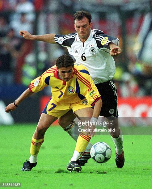 Der deutsche Fußballspieler Jens Nowotny kämpft am im Europameisterschaftsspiel Deutschland - Rumänien gegen Adrian Mutu um den Ball. .