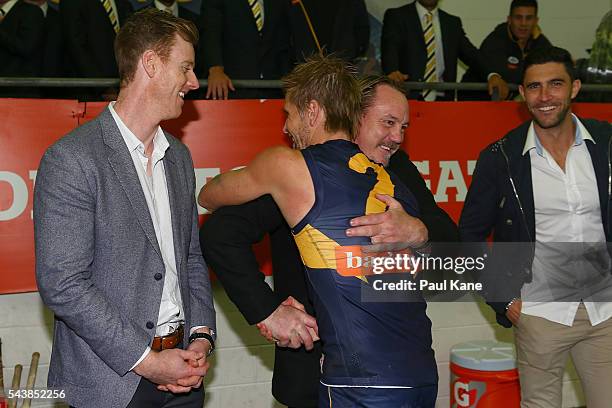 Former Eagles player Daniel Chick is embraced by Mark LeCras of the Eagles after the round 15 AFL match between the West Coast Eagles and the...