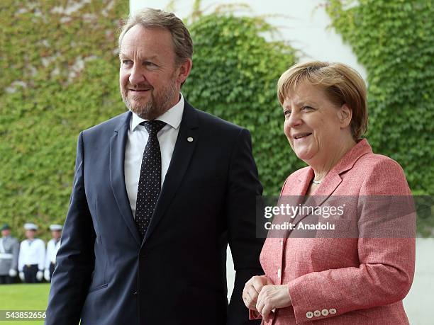 Germany's Chancellor Angela Merkel and Bosnian member of the Tripartite Presidency of Bosnia and Herzegovina Bakir Izetbegovic pose for photographer...