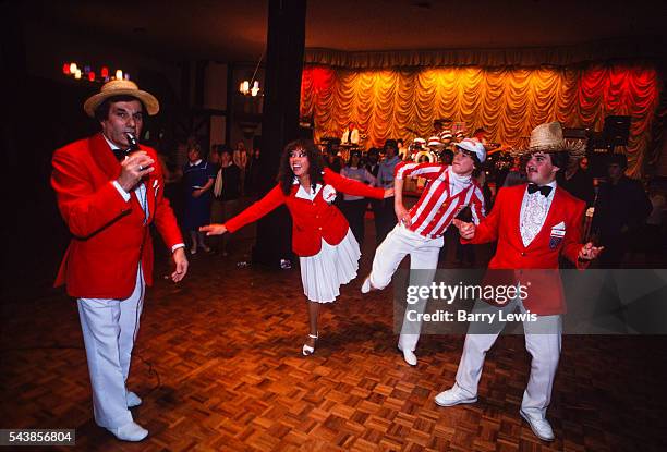 Redcoats entertaining in the Empress Ballroom, Butlins Skegness. The idea for the Red Coats came to Butlin early on in the Skegness Camp's first...