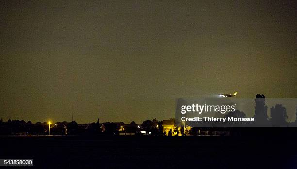 Zaventem, Belgium, April 20, 2014. -- A plane is landing at night in Brussels National airport.