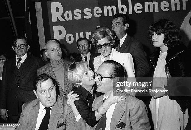 Paris Mayor Jacques Chirac receives a hug from a woman during his visit to Porto-Vecchio, while Charles Pasqua looks on.