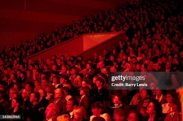 Large crowd, bathed in red light, watch one of the regular evening entertainments in the Gaiety Theatre at Butlins holiday camp at Skegness. Butlins...