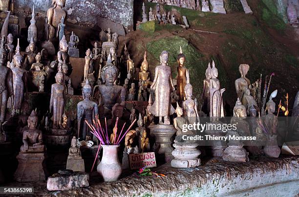 Pak Ou Caves, Laos, August 2003. -- The Pak Ou Caves, 25 km to the north of Luang Prabang. The caves are noted for their miniature Buddha sculptures....