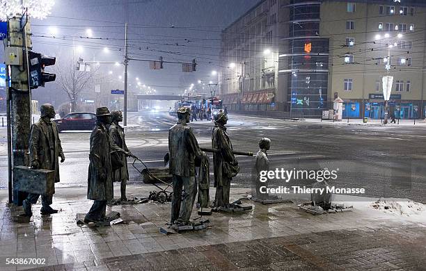 Wroclaw, Poland, January 2, 2006. -- 14 Bronze statues designed by Polish artist Jerzy KALINA representing people descending into the earth that make...