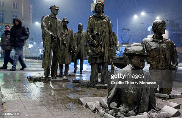 Wroclaw, Poland, January 2, 2006. -- 14 Bronze statues designed by Polish artist Jerzy KALINA representing people descending into the earth that make...