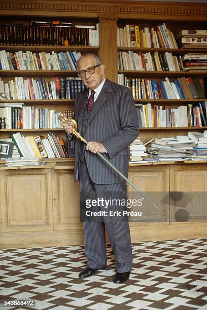 French Americanist, ethnologist, politician and essayist Jacques Soustelle in his home. He holds the sword that claims him a member of the Academie...