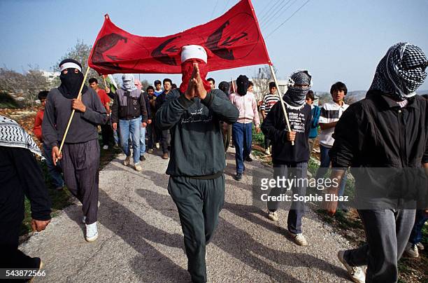 Members of Geroge Habache's FPLP party commemorate Martyrs Day in a village overlooking Ramallah in the Occupied Territories. Shouting anti-Israeli...