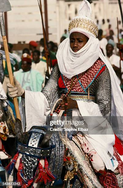 Ado Bayero, wearing religious clothing, parades every year throughout the streets of his city, with veils barely showing his face to a benevolent...