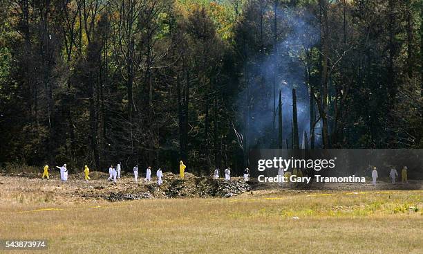 Emergency workers look over the site where the Boeing 757 of United Airlines crashed near Shanksville, Pennsylvania.