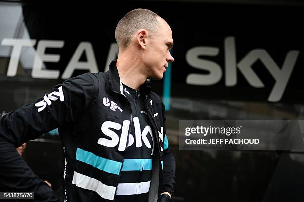 Great Britain's Christopher Froome walks past the team bus prior to a training session of cyclists of the Great Britain's Sky cycling team, in...