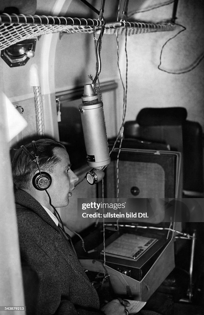 Radio presenter is informing about the traffic news from an aircraft - Photographer: Curt Ullmann- Published by: 'Hier Berlin' 41/1936Vintage property of ullstein bild