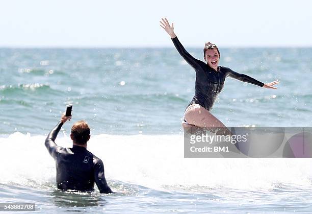 Australian model Montana Cox enjoys a surf in The Hamptons on June 26, 2016 in New York.