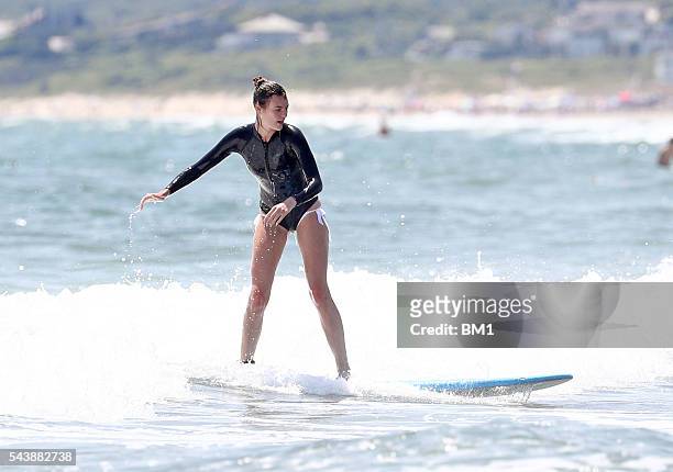 Australian model Montana Cox enjoys a surf in The Hamptons on June 26, 2016 in New York.