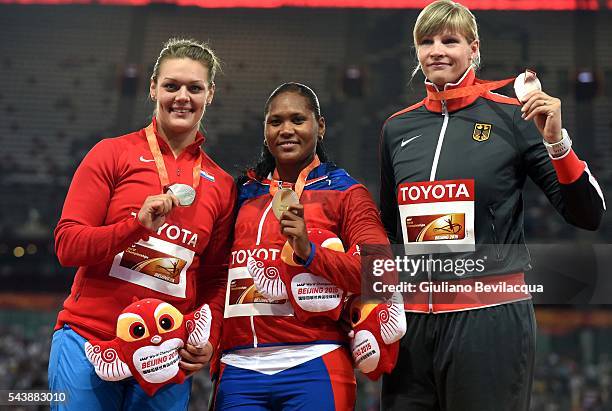 Discus women podium from right: Nadine Mueller, Germany, bronze, Denia Caballero, Cuba the winner, Sandra Perkovic of Croatia, silver