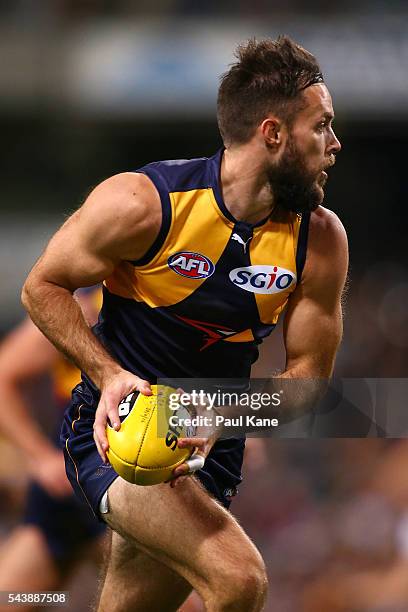 Mitchell Brown of the Eagles looks to pass the ball during the round 15 AFL match between the West Coast Eagles and the Essendon Bombers at Domain...