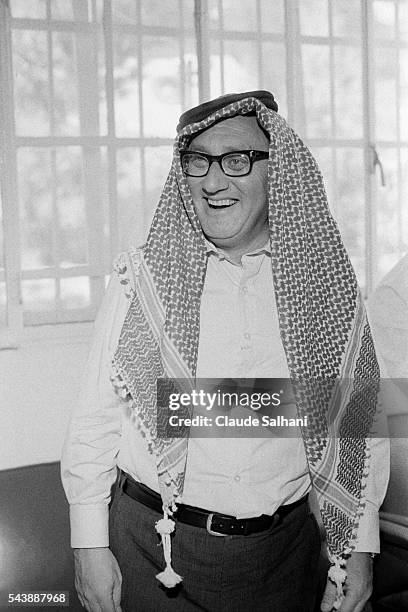 American Secretary of State Henry Kissinger, on an official visit in Amman, is offered a traditional Bedoin Kaffiyeh, today worn by the entire Arab...