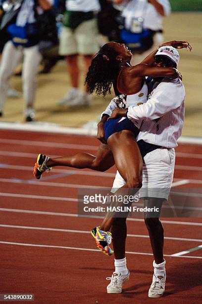 Sprinter Gail Devers celebrates with her coach Bob Kersee after winning the women's 100 meter final at the 1996 Olympic Games.