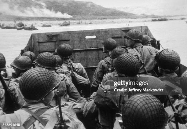 Platoon of soldiers are transported to Omaha Beach via landing vehicle during D-Day.