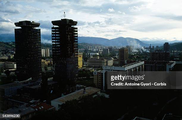 The Unis Towers overlook the city of Sarajevo while the city is besieged during the Yugoslavian Civil War. The siege of Sarajevo continued until a...