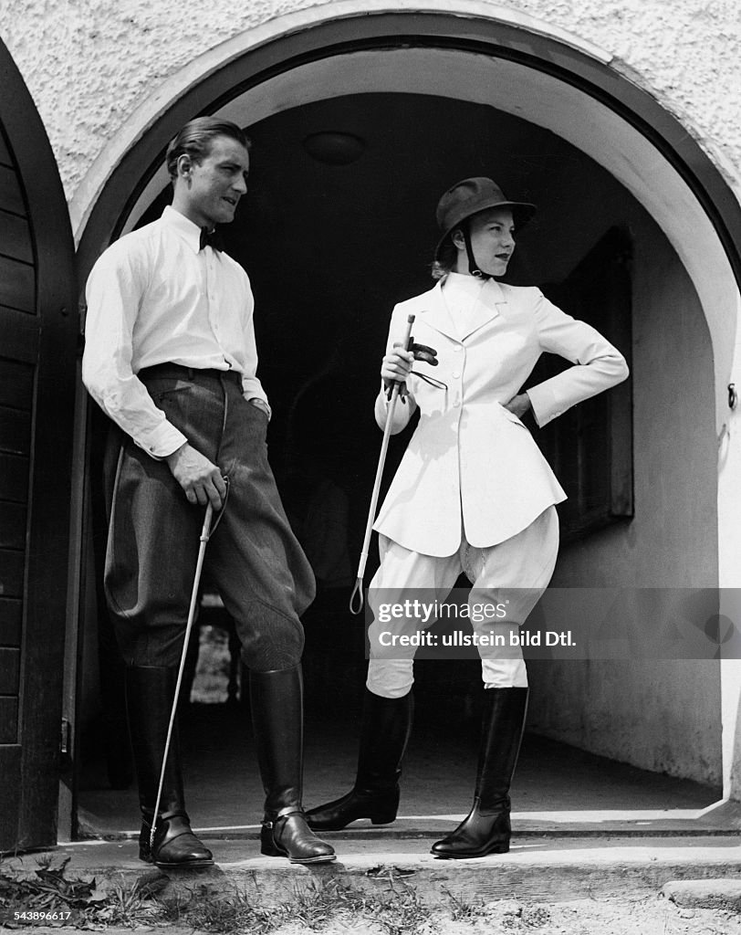 German Empire Free State Prussia : Man and woman in horse riding clothes, she is wearing white breeches and a waisted silk jacket, design: Hoffmann - Photographer: Peter Weller- Published by: 'Deutsche Allgemeine Zeitung' (DAZ) 13.08.1939Vintage prop