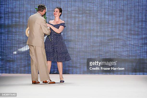 Designer Lena Hoschek gets flowers from Reinhard Maetzler after her show during the Mercedes-Benz Fashion Week Berlin Spring/Summer 2017 at Erika...