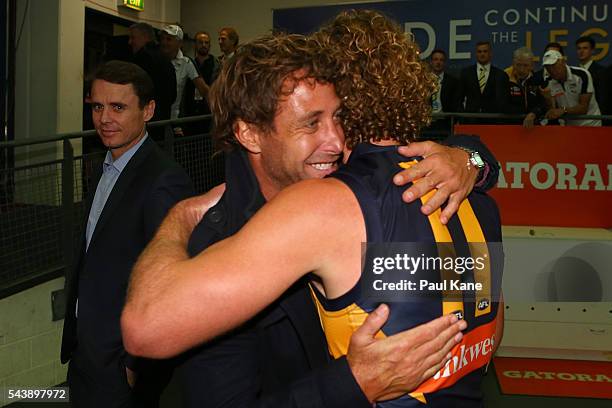 Former Eagles player Chad Fletcher and Matt Priddis of the Eagles embrace after the round 15 AFL match between the West Coast Eagles and the Essendon...