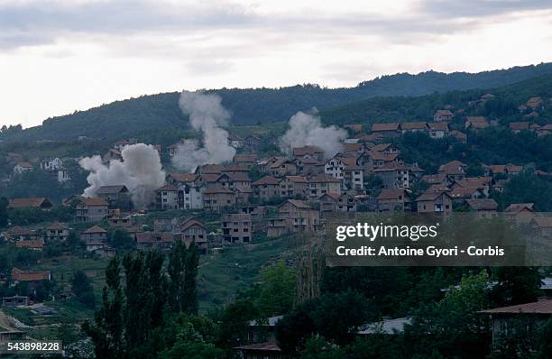 Plumes of smoke rise from a residential area of Sarajevo during the siege of the city in the Yugoslavian Civil War. Serbian troops spread out into...