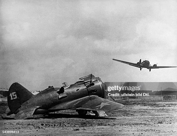 Campaign against soviet union /eastern front, Theater of war: Airfield - a cargo plane Ju-52 in the air; foreground a disabled soviet Plikarpov I-16...