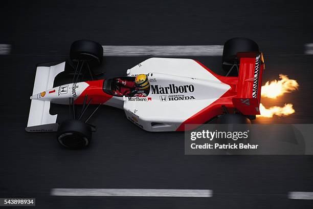 Flames shoot out from under the Formula One racecar of driver Ayrton Senna, of the McLaren-Honda racing team, during the 1991 Monaco Grand Prix.
