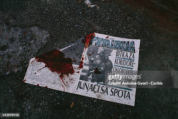 Bloodstained newspaper lies in a Sarajevo street during the city's siege in the Yugoslavian Civil War. In March of 1992, Bosnia and Herzegovina...