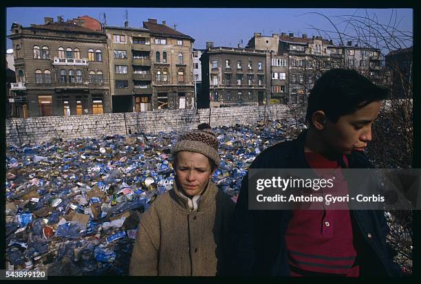 Two boys stand near a garbage dump during the siege of Sarajevo in the Yugoslavian Civil War. In March of 1992, Bosnia and Herzegovina declared...