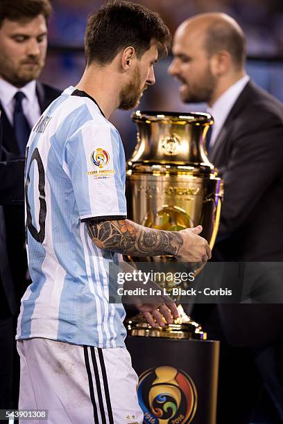 Argentina forward and captain Lionel Messi waits to take his 2nd place medal and passes the Copa America Cup after the Copa America Centenario final...