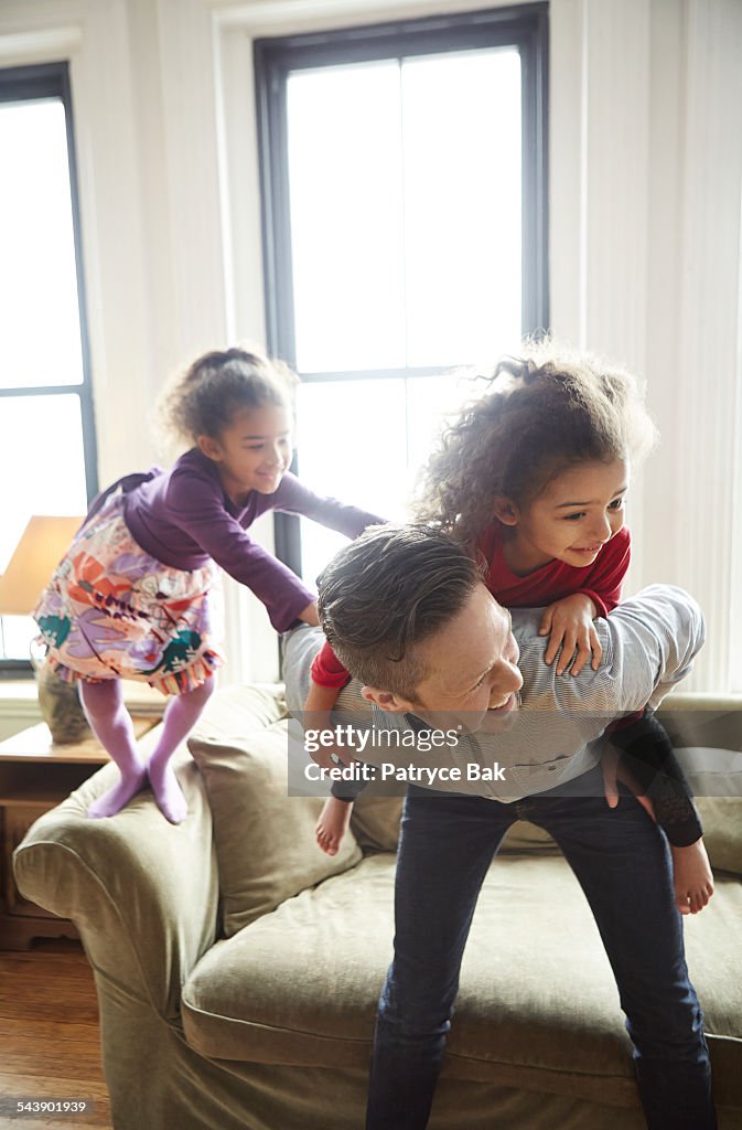 Transgender dad playing with daughters