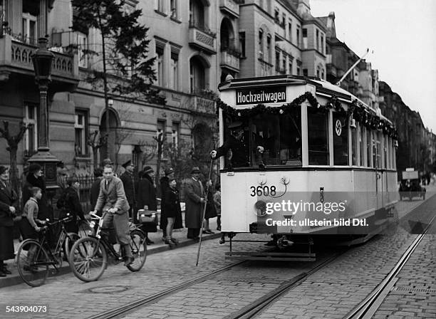 Wedding streetcar is passing throught the streets of Friedenau decorated with festoons and swastika flags at the occasion of the wedding of an...