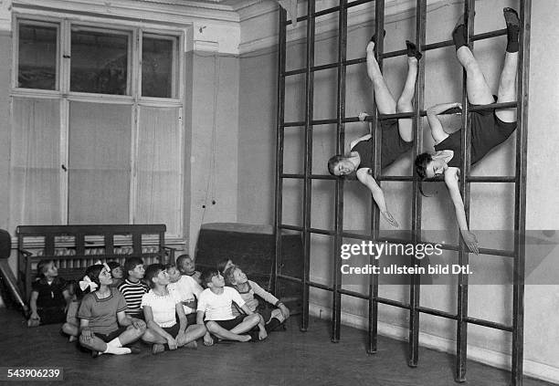 Sweden Scholars at gymnastic exercises at the wall bars. - Photographer: Sennecke- 1920Vintage property of ullstein bild
