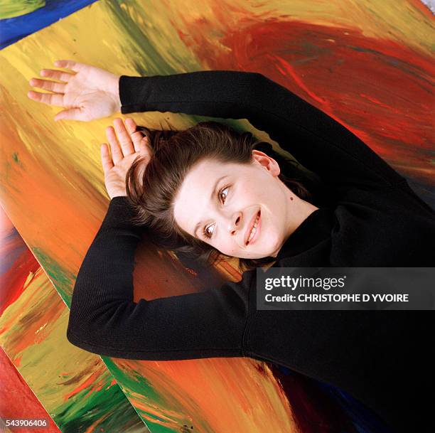 Juliette Binoche with paintings of her own creation.