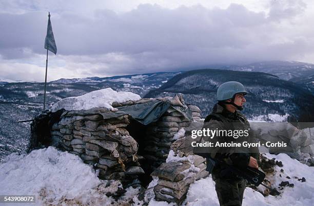 Soldier of the French Army stands guard at an observation point on Mount Igman, overlooking Sarajevo. | Location: Near Sarajevo, Bosnia and...