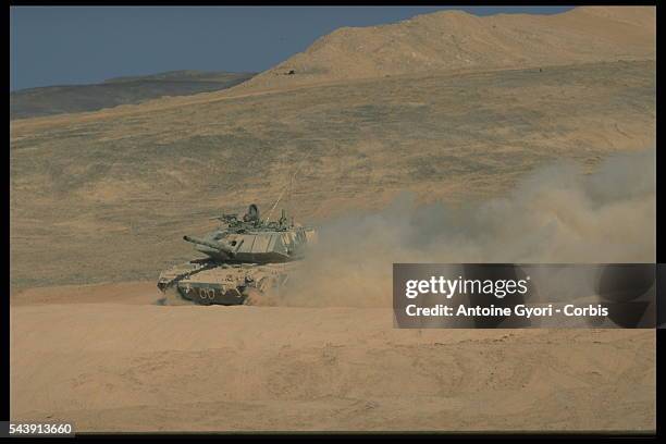 Merkava tank maneuvering in the sand of the Neguev desert.