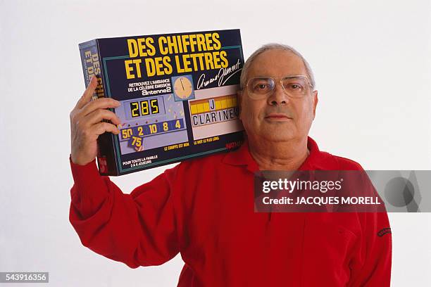 Armand Jammot with a copy of the board game Des chiffres et des lettres based on his famous television game show.