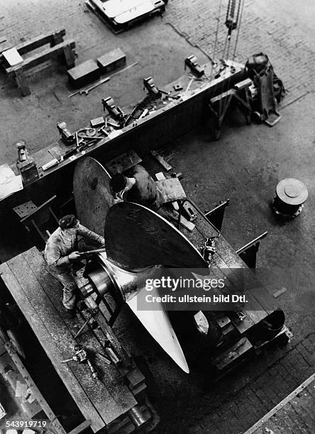Germany Free State Prussia Schleswig-Holstein Province Kiel: Series shipbuilding: Friedrich Krupp Germaniawerft - workers in the assembly hangar...