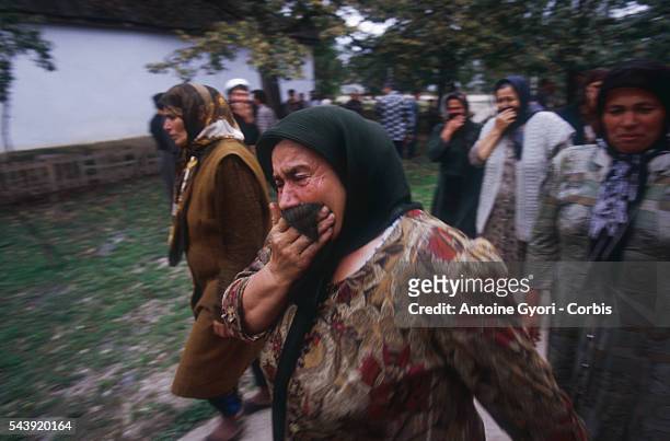 Women weeping after the bombing of a Chechen village by the Terek river.