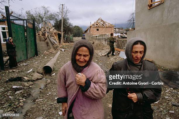 Local women sob in the devastated streets of Grozny after a Russian bombardment of the capital.