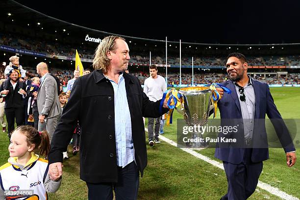 Daniel Chick and David Wirrpanda walk a lap of honour with team mates celebrating the West Coast Eagles 2006 Premiership anniversary during the round...
