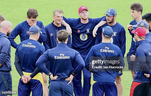 Ben Stokes of Durham leans on team-mate Phil Mustard and Scott Borthwick whilst warming up during the NatWest T20 Blast game between Durham Jets and...