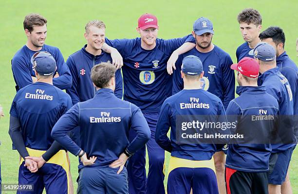 Ben Stokes of Durham leans on team-mate Phil Mustard and Scott Borthwick whilst warming up during the NatWest T20 Blast game between Durham Jets and...