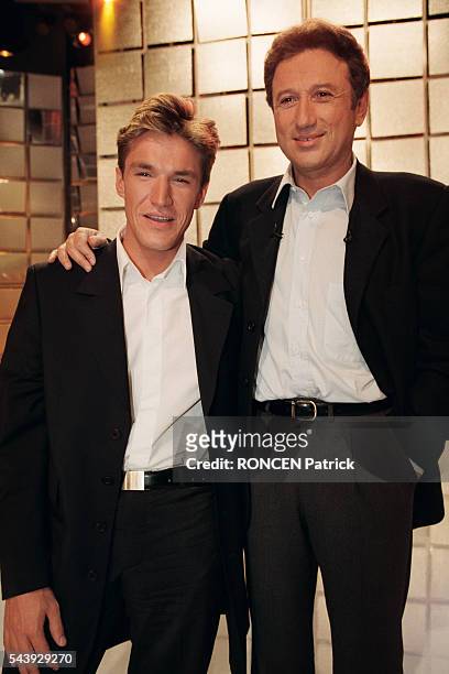 Talk show host Benjamin Castaldi and television host Michel Drucker on the set of television show Vivement Dimanche.