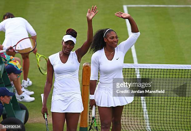 Venus and Serena Williams of The United States celebrates victory during the Ladies Doubles first round match against Andreja Klepac of Slovakia and...