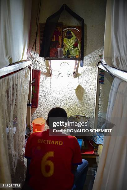 An inmate eats in a bedroom at the mixed-sex prison of Tulancingo, Hidalgo State, Mexico, on June 29, 2016. Men and women, 549 in total, live...